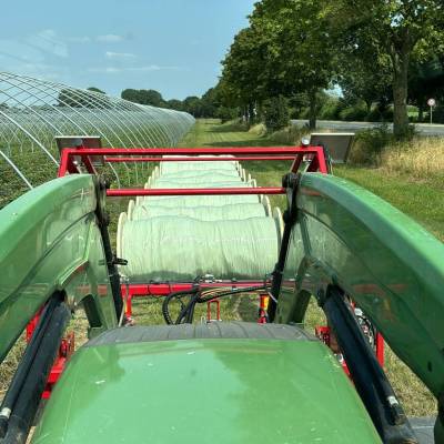 Wiesel 2400 attached to front loader when winding greenhouse film